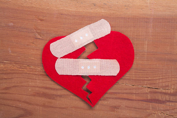 Tiny red heart sign isolated on wooden background. Red heart sign isolated on wooden background. Heart broken, love and valentines day concept. pulse orlando night club & ultra lounge stock pictures, royalty-free photos & images