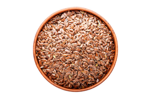 istock flax seeds in a plate isolated, on white background, top view 1055222662