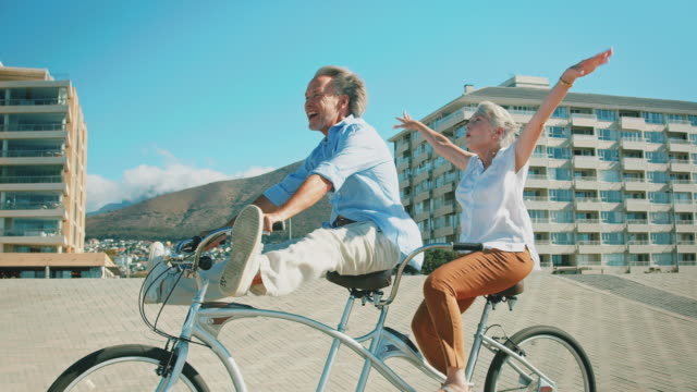 Happy senior couple enjoying on tandem bicycle
