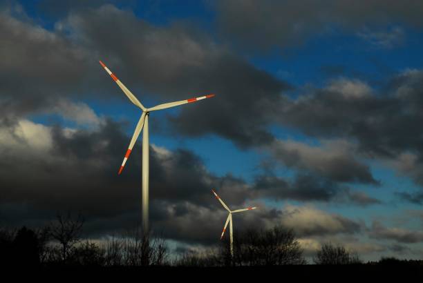 istock Wind Turbines On Field Against Cloudy Sky 1055226132