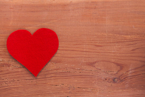 Tiny red heart sign isolated on wooden background. Red heart sign isolated on wooden background. Heart broken, love and valentines day concept. pulse orlando night club & ultra lounge stock pictures, royalty-free photos & images