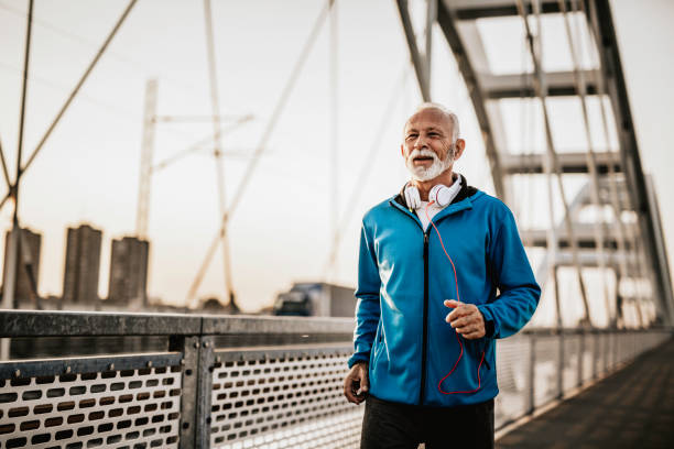 istock Senior man running over the bridge 1055228674