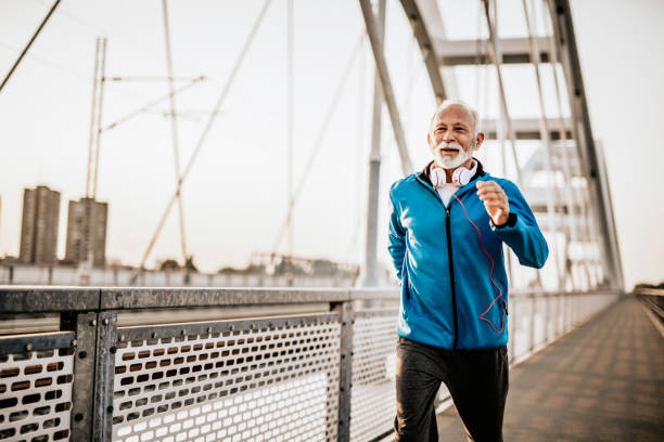 istock Senior man running over the bridge 1055228940