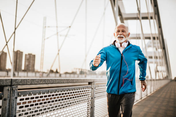 Senior man running over the bridge