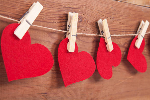 Tiny red heart sign isolated on wooden background. Red heart sign isolated on wooden background. Heart broken, love and valentines day concept. pulse orlando night club & ultra lounge stock pictures, royalty-free photos & images