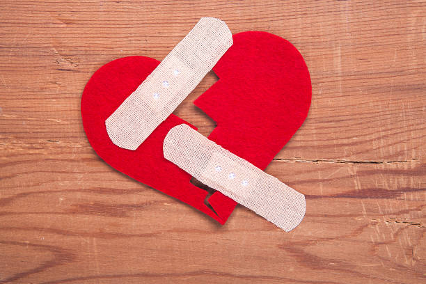 Tiny red heart sign isolated on wooden background. Red heart sign isolated on wooden background. Heart broken, love and valentines day concept. pulse orlando night club & ultra lounge stock pictures, royalty-free photos & images