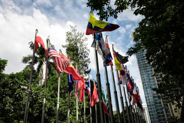 istock Various countries flags at flagpoles in a row 1055235522
