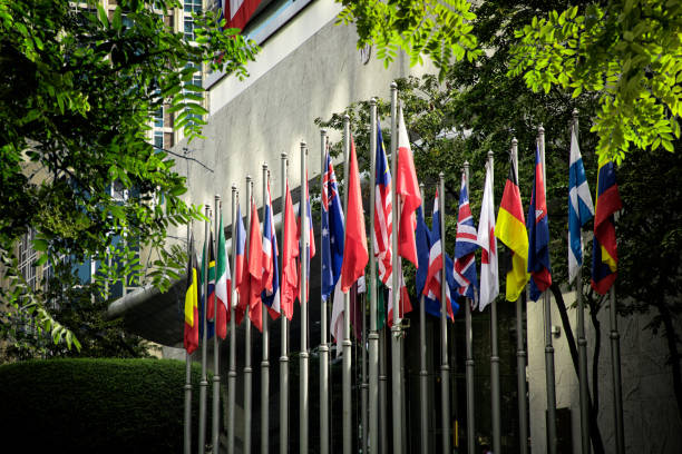 istock Various countries flags at flagpoles in a row 1055236102