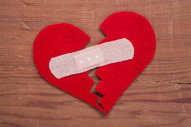 Tiny red heart sign isolated on wooden background. Red heart sign isolated on wooden background. Heart broken, love and valentines day concept. pulse orlando night club & ultra lounge stock pictures, royalty-free photos & images