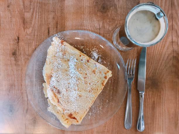 istock Breakfast with coffee and crepes with sugar 1055237276