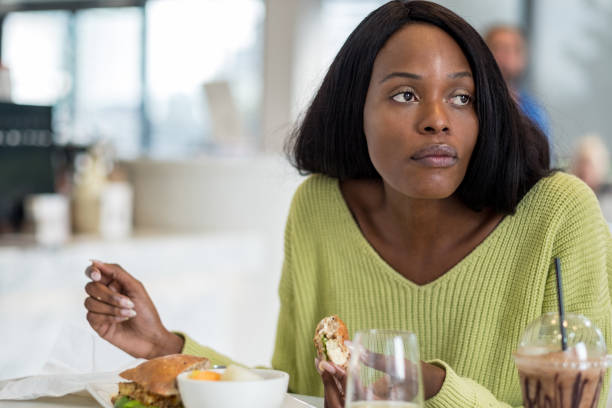 istock Young black woman at lunch 1055240720