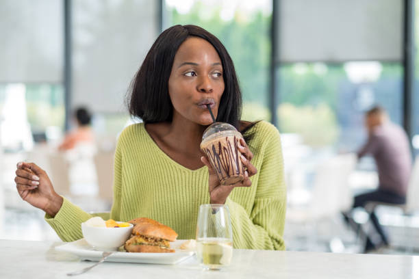 istock Young black woman at lunch 1055240750