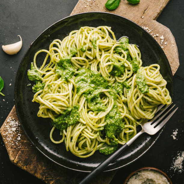 istock Tasty pasta with pesto served on plate 1055246374