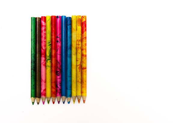 istock set of colored pencils lying on the notebook. White background. Isolate. Christmas colors 1055246702