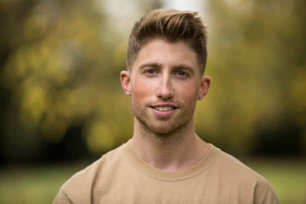 istock Portrait Of Young Man Against Trees 1055247442