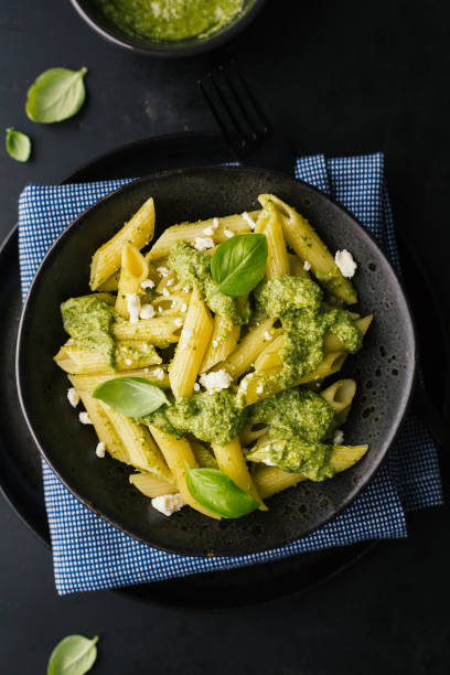istock Tasty pasta with pesto served on plate 1055247746