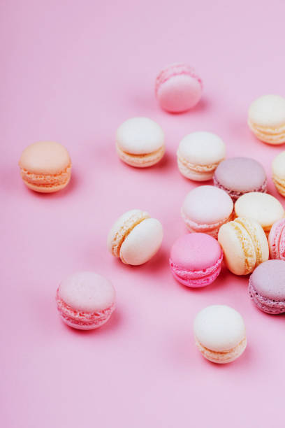 istock Sweet macaroons with vintage pastel colored tone on pink background. 1055249816