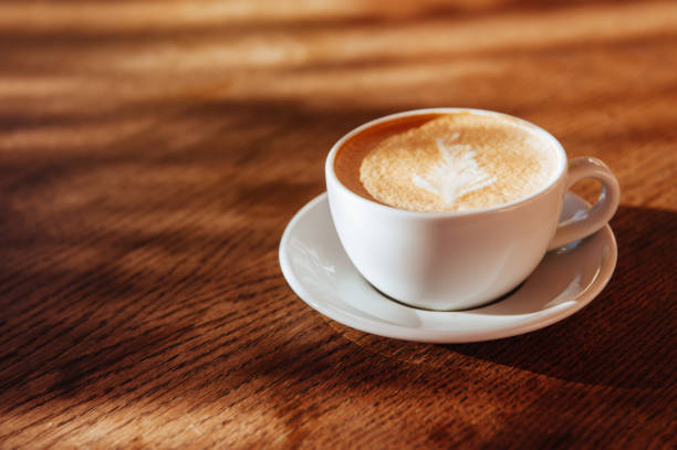 istock coffee cup latte art in cafe 1055250026