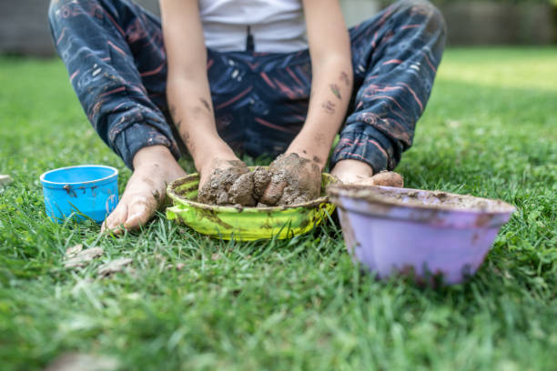 istock Toddler child playing with mud 1055255076