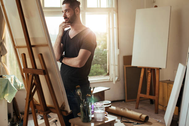 istock Young man painting 1055260222