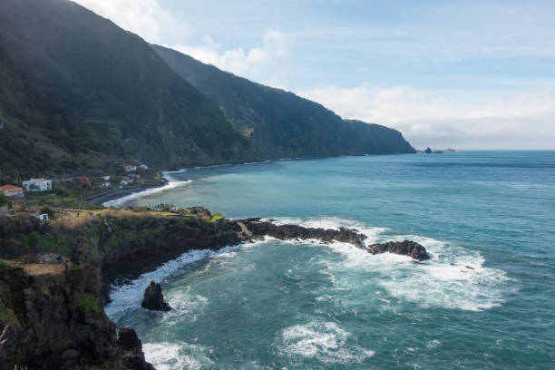 istock Beautiful black rock beach in Seixal, Madeira with waves crashing 1055260356