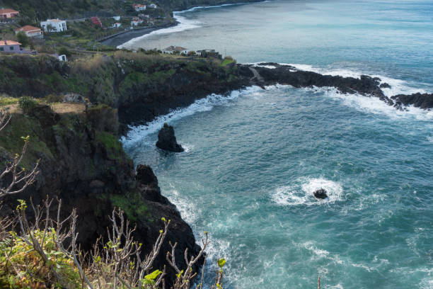 istock Beautiful black rock beach in Seixal, Madeira with waves crashing 1055260502