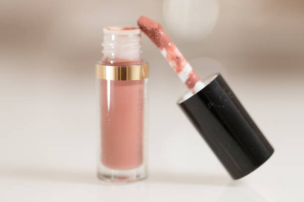 istock brush for lipgloss, lipstick red, pink on white background 1055260534