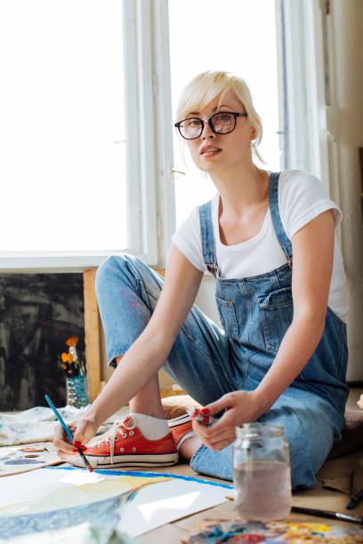 istock Girl painter in a bright atelier 1055260648