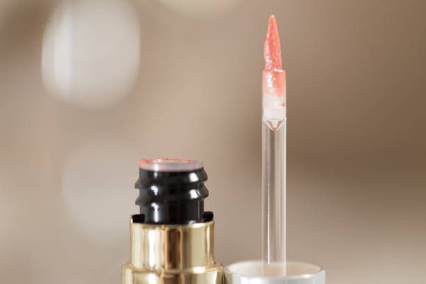 istock brush for lipgloss, lipstick red, pink on white background 1055261164