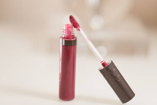 istock brush for lipgloss, lipstick red, pink on white background 1055263462