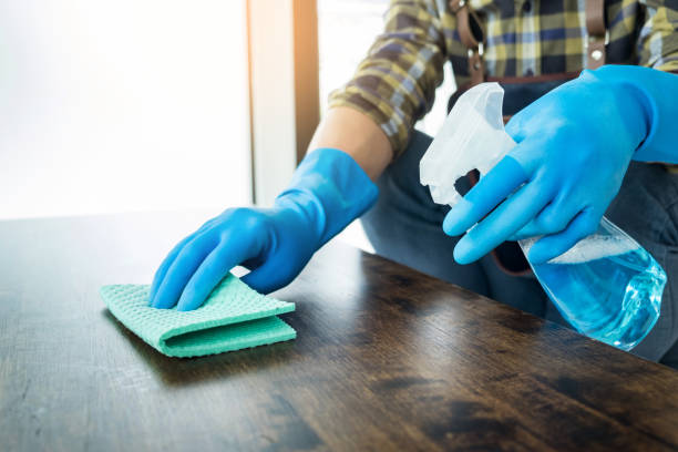 istock Midsection Of Man Cleaning Wooden Table 1055263616