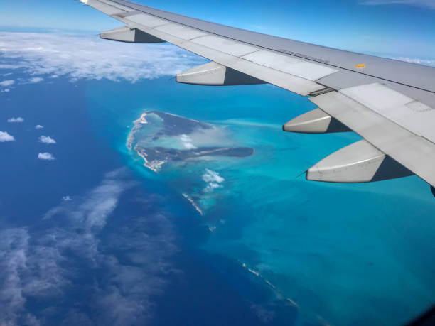 istock Caribbean island from airplane window, and wing 1055263682