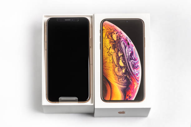 latest iphone xs in unopened box on white table. newest apple smartphone on white branded box in mobile store. - store application software iphone mobile phone imagens e fotografias de stock