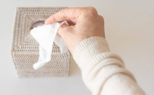 istock Cropped Hand Holding Tissue Paper On Table 1055265446