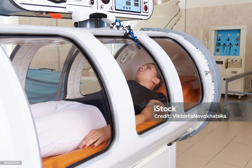 Girl patient lying in a hyperbaric chamber. Hyperbaric Medicine Stock Photo