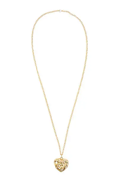 Photo of Heart shaped gold necklace on white background