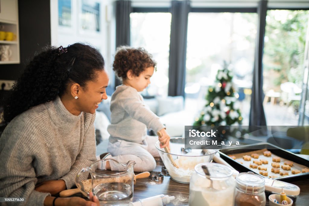 The true spirit of Christmas Mother and cute boy at kitchen Christmas Stock Photo