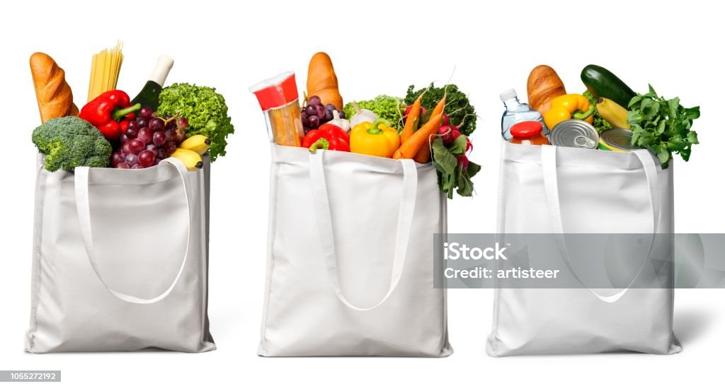 Groceries. Shopping bags with groceries isolated on white Groceries Stock Photo