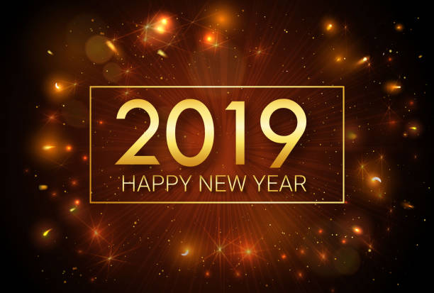 istock Happy New Year 2019. Greeting golden inscription on the background of fireworks. An explosion of fireworks against a dark background. 1055278024