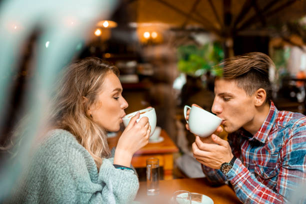 istock Young couple enjoying their coffee in a bar 1055287206
