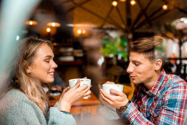 istock Young couple enjoying their coffee in a bar 1055287212