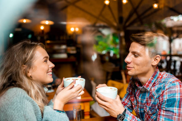 istock Young couple enjoying their coffee in a bar 1055287214
