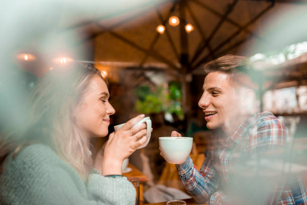 istock Young couple enjoying their coffee in a bar 1055287216