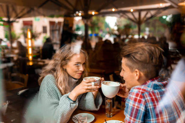 istock Young couple enjoying their coffee in a bar 1055287222