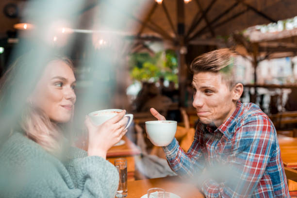 istock Young couple enjoying their coffee in a bar 1055287228