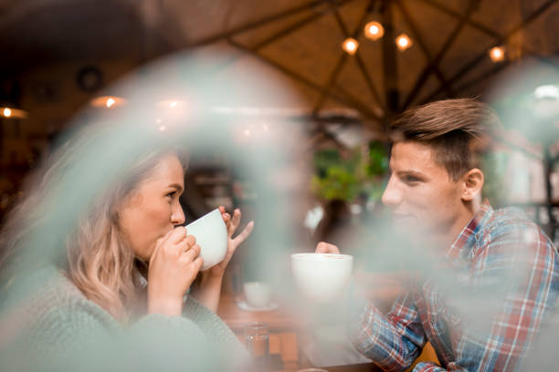 istock Young couple enjoying their coffee in a bar 1055287232