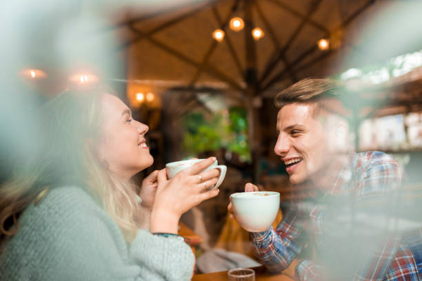 istock Young couple enjoying their coffee in a bar 1055287234