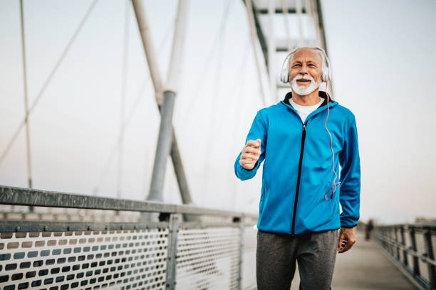 istock Senior man running over the bridge 1055287360