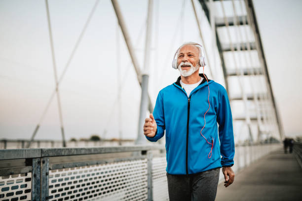 istock Senior man running over the bridge 1055287376