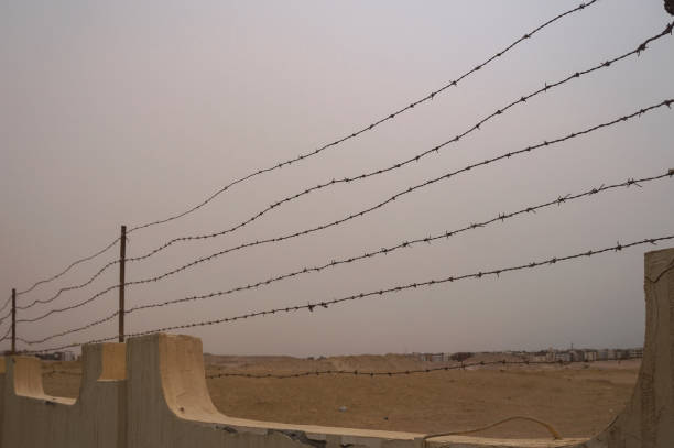 Restrictive fence with barbed wire. Tour area conc camp. Genocide during the war. Stock photo stock photo